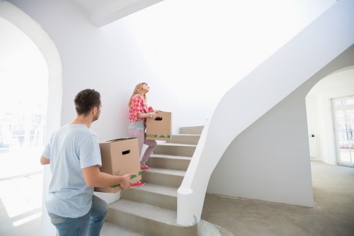Unloading removal boxes into a modern flat in Bow near local East London streets